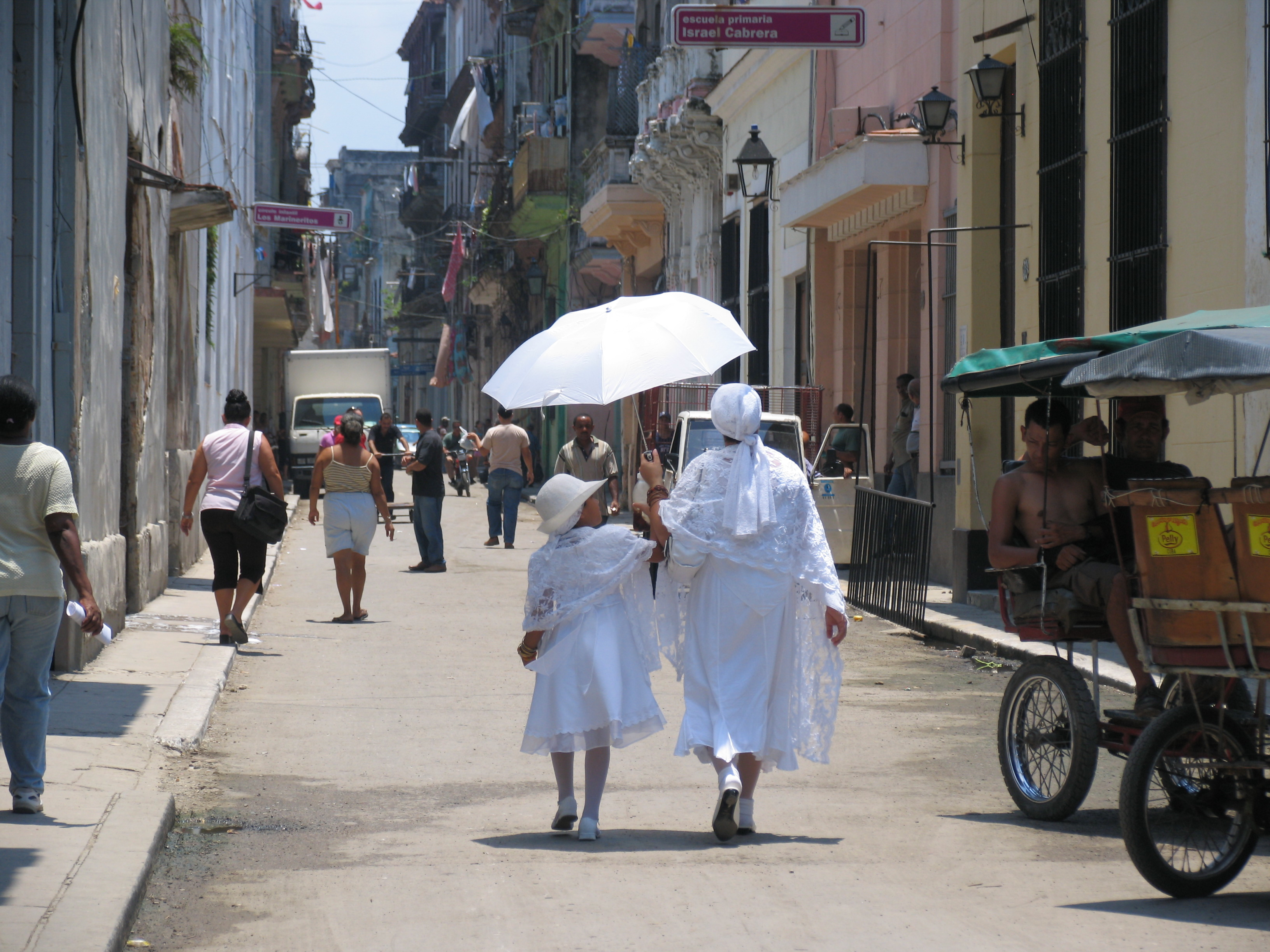 Photo © Lillian Guerra. A grandmother and granddaughter dressed as yabós, as part of their baptismal and ritual entry into the Santería faith, Old Havana, Cuba, 2011. After decades of repression of Santería, the main Afro-Cuban religion, the Cuban government's lifting of sanctions against its practice has revitalized it enormously. Multiple generations are now rediscovering their black identities through the religion their ancestors used to help them survive slavery.